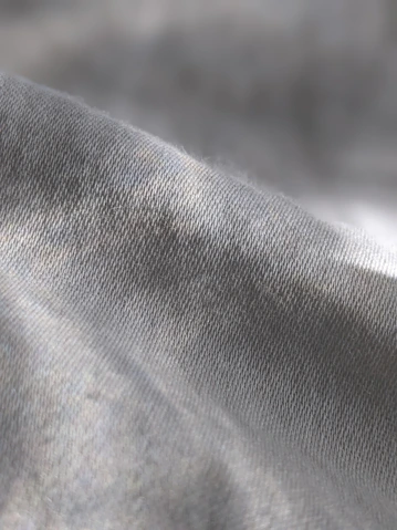 a close up of a gray fabric with a blurry background