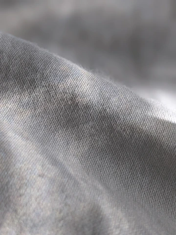 a close up of a gray fabric with a blurry background