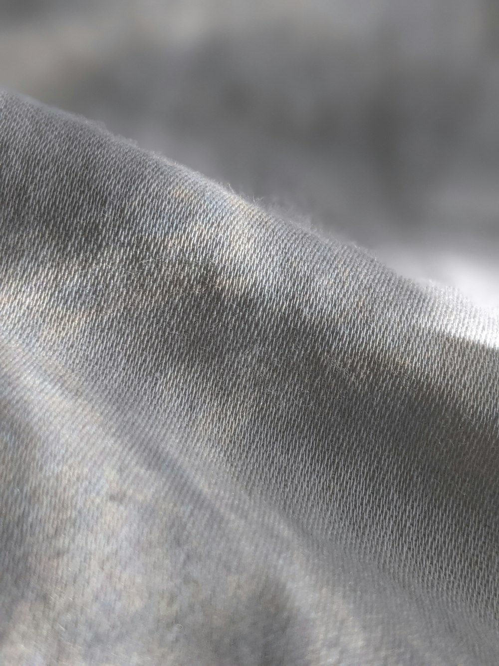 a close up of a gray fabric with a blurry background