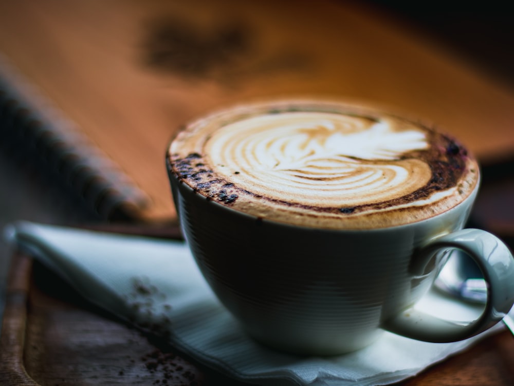 a cappuccino on a saucer with a spoon