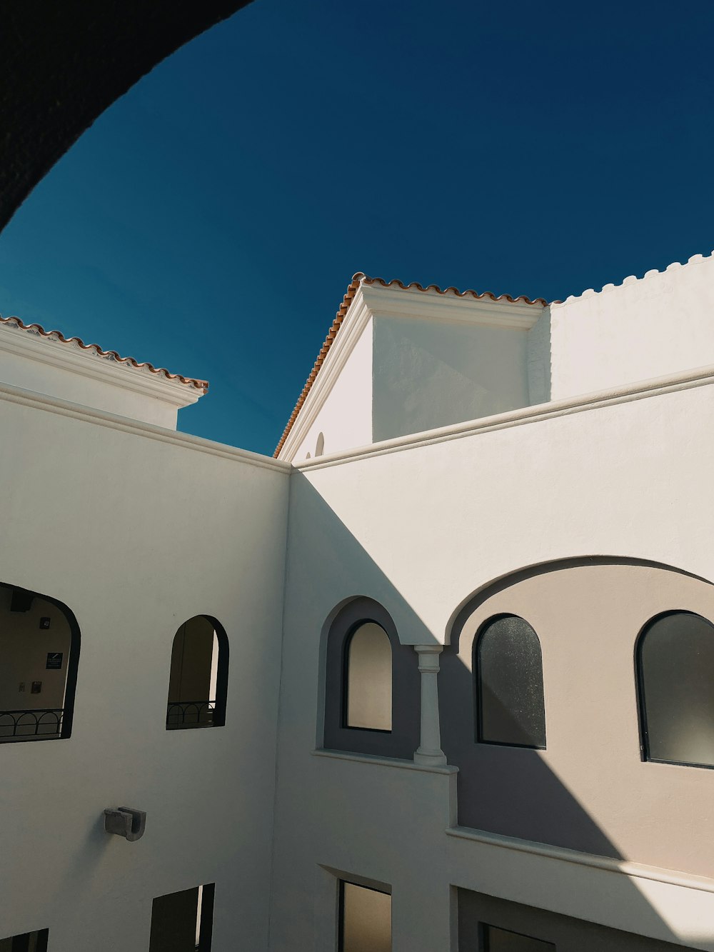 a white building with arched windows under a blue sky