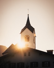 a church with a steeple and a clock at the top