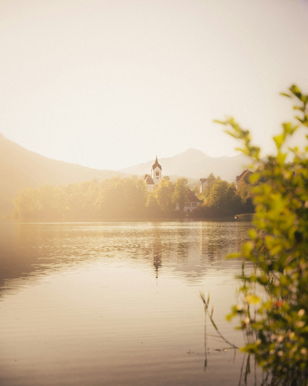 a body of water with a church in the background