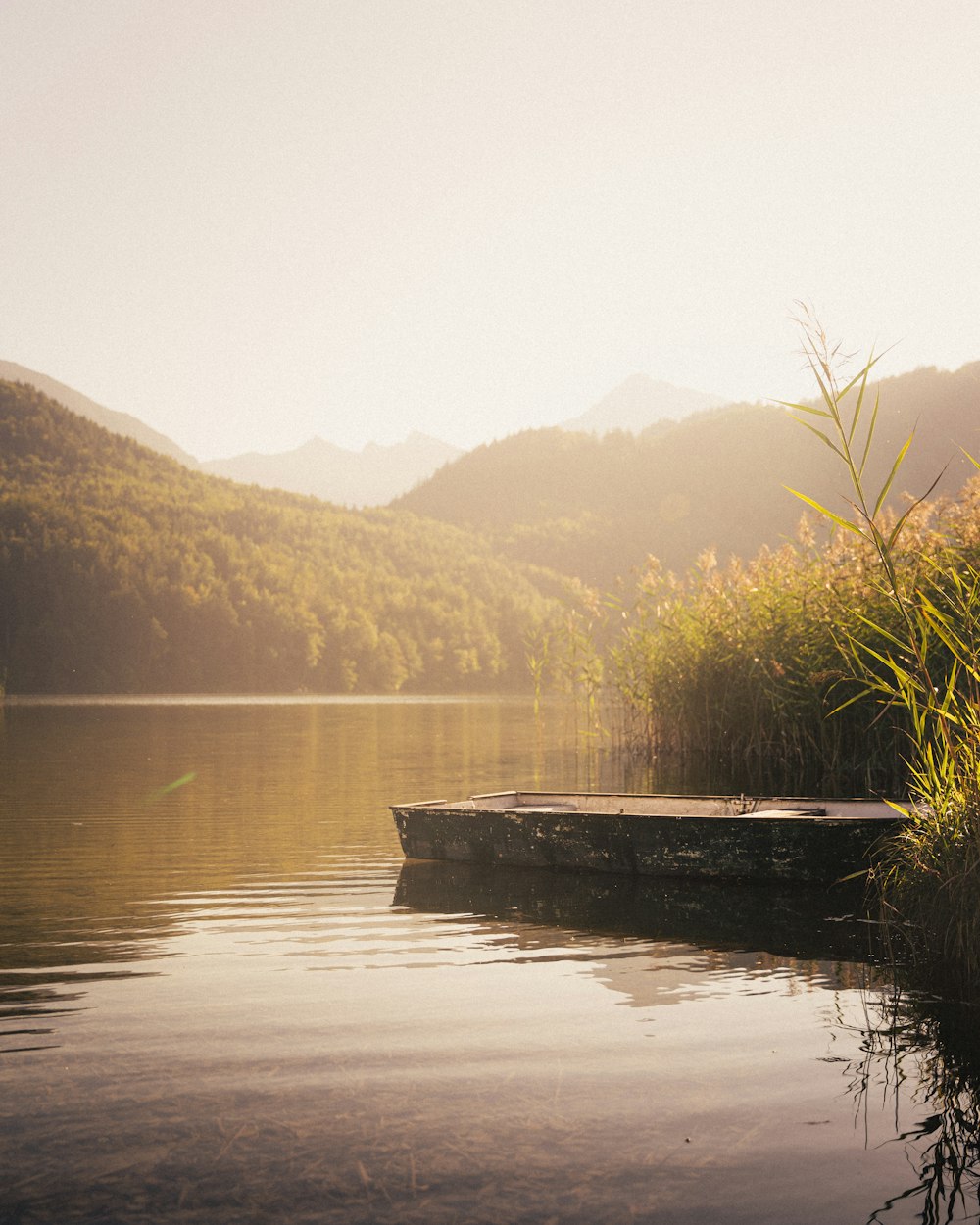 a small boat floating on top of a lake