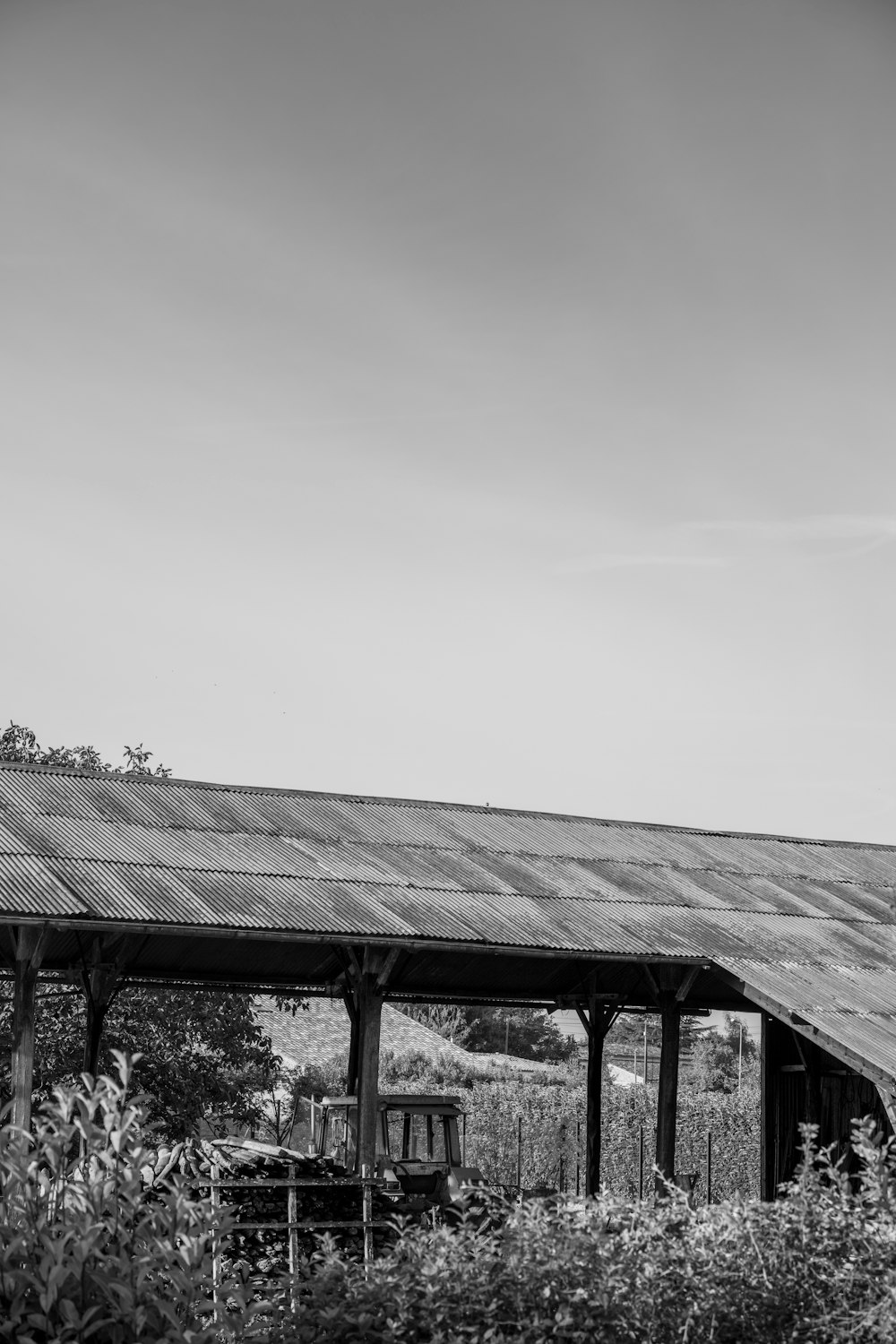 a black and white photo of an old barn