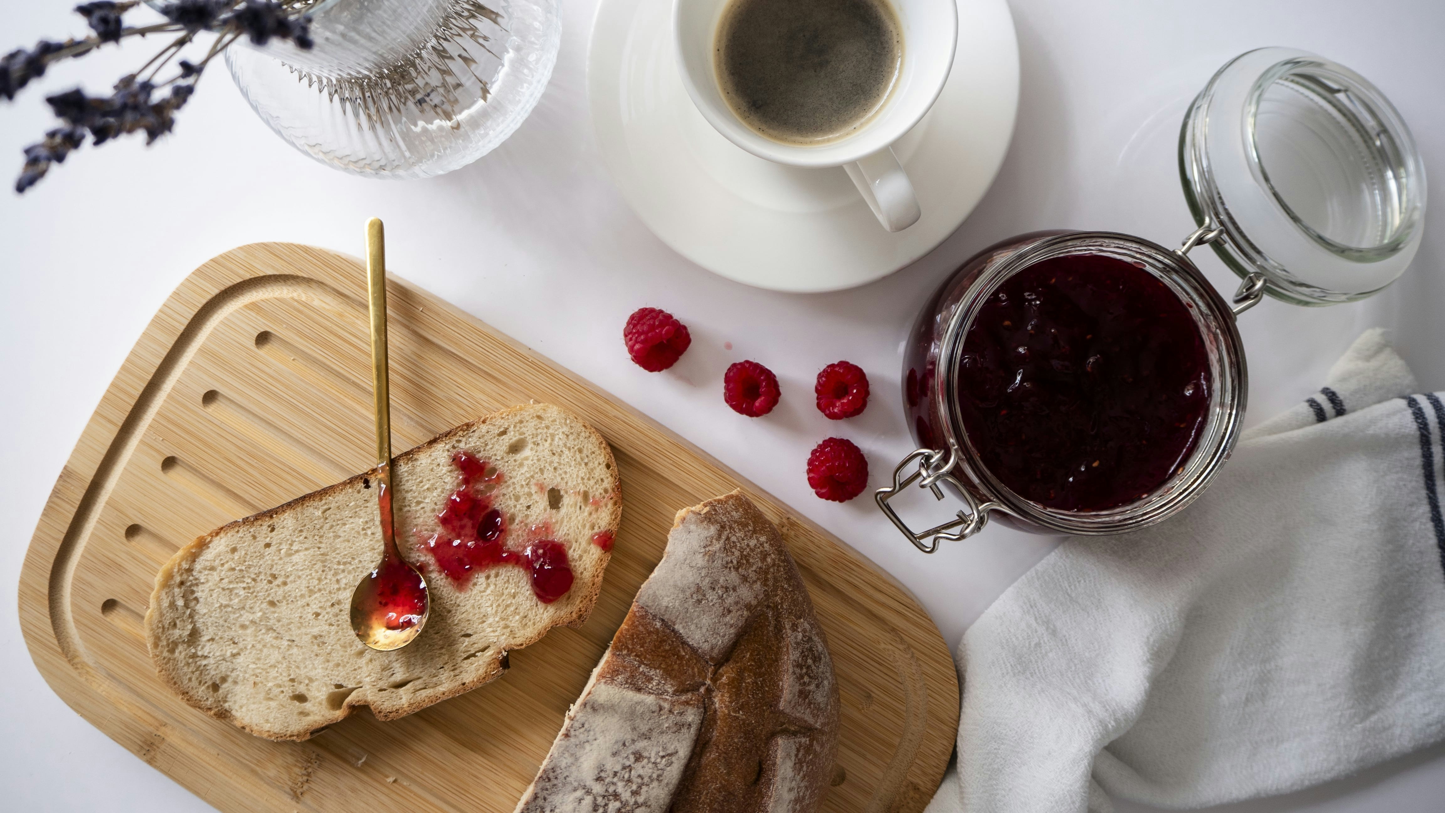 a loaf of bread with raspberry jam and a cup of coffee, Autumn breakfast