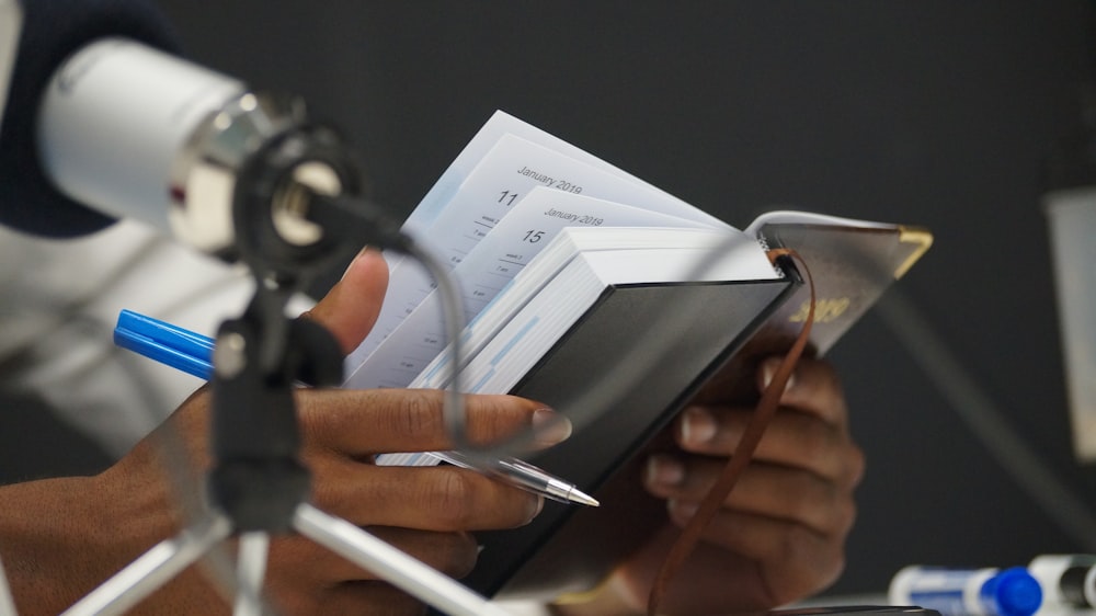 a person holding a tablet and a camera