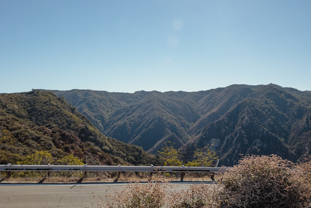 a bench sitting on the side of a road