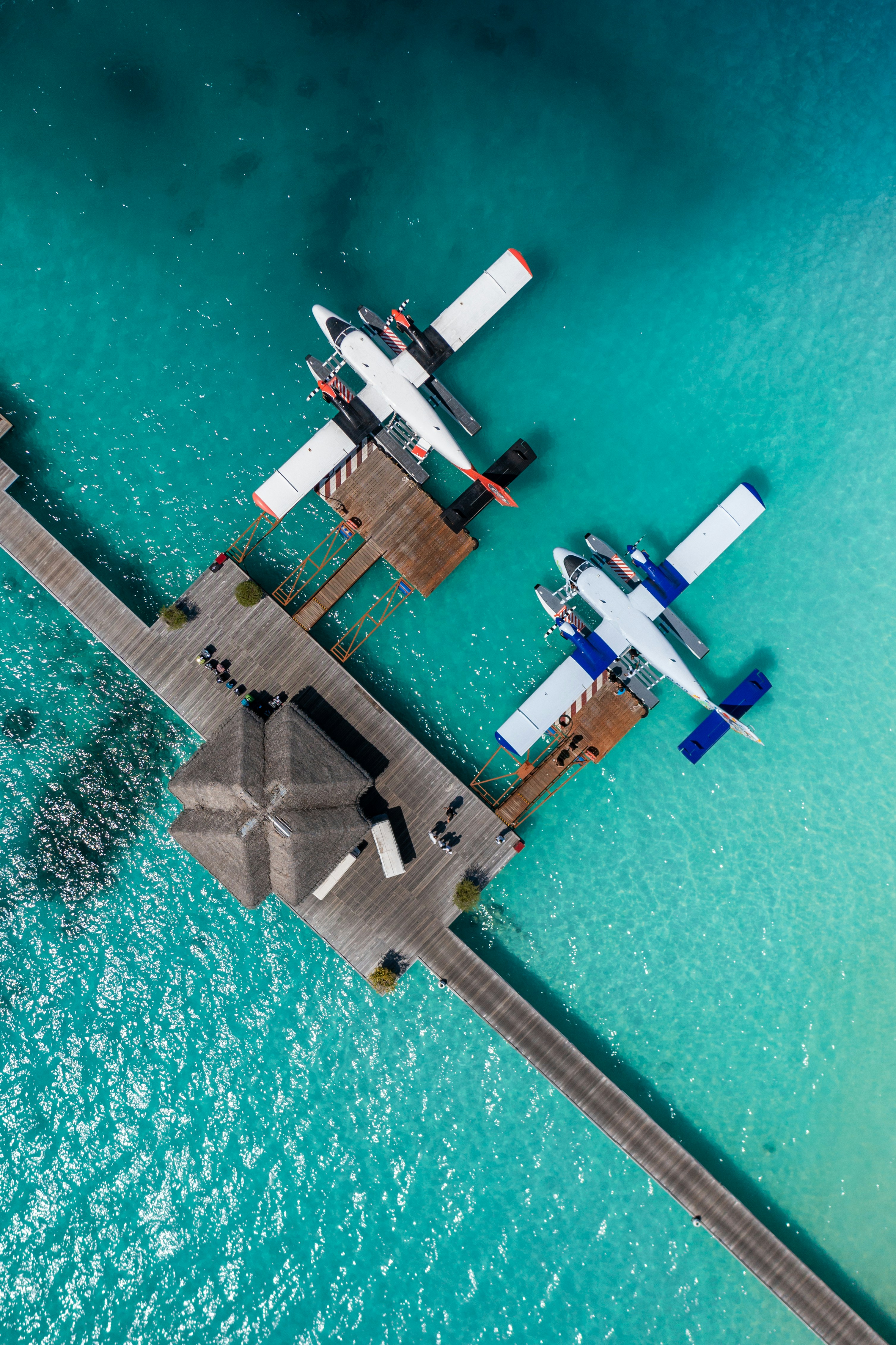 A couple of airplanes that are flying over water photo Free Water