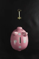Close-up of hands holding a small piggy bank symbolizing savings for children