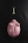 A pink piggy bank with white polka dots lying on a dark textured surface, accompanied by a golden key placed above it.