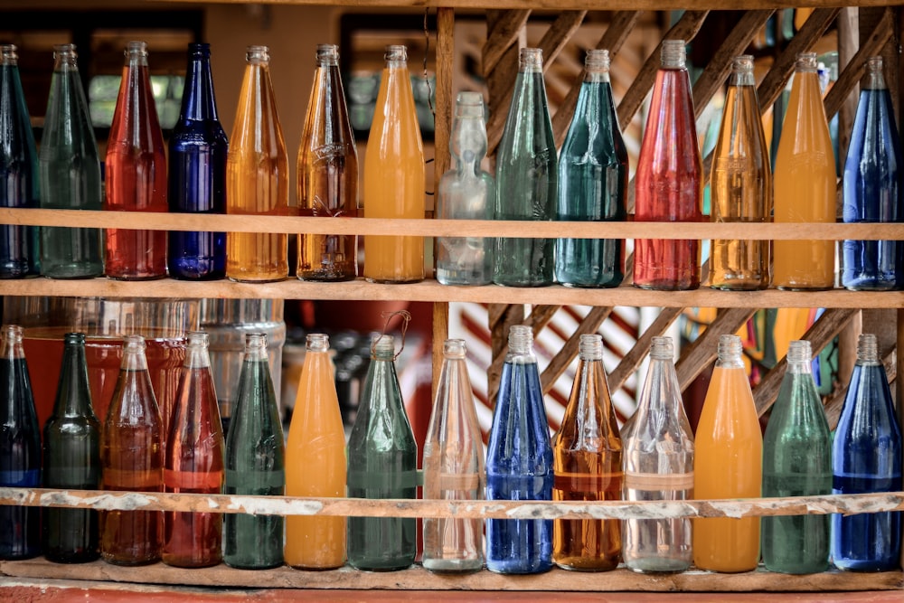 a shelf filled with lots of different colored bottles