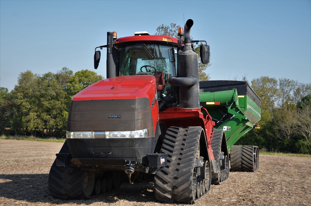 a red tractor is parked in a field