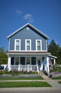 a blue house with a white picket fence