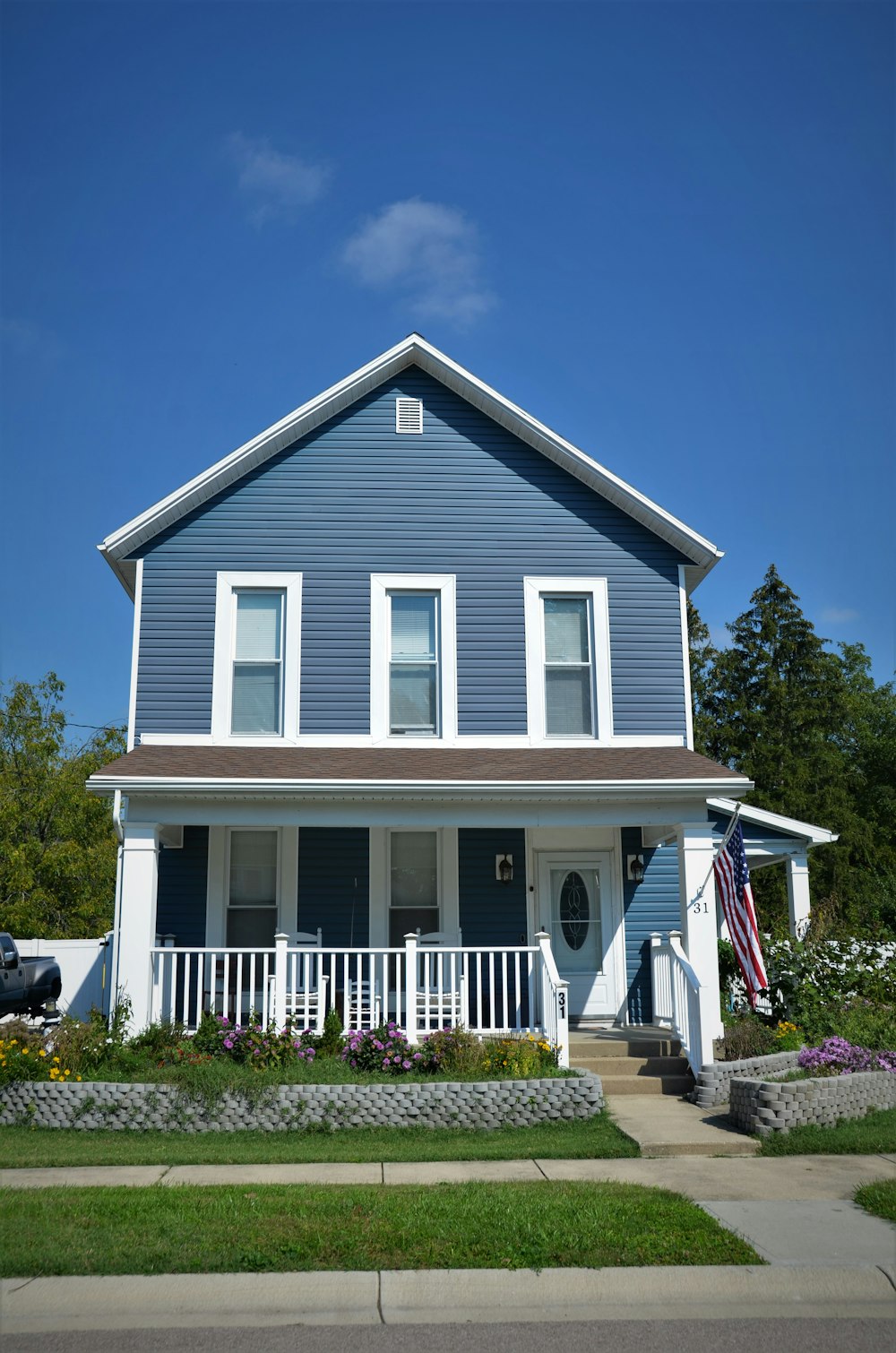 a blue house with a white picket fence