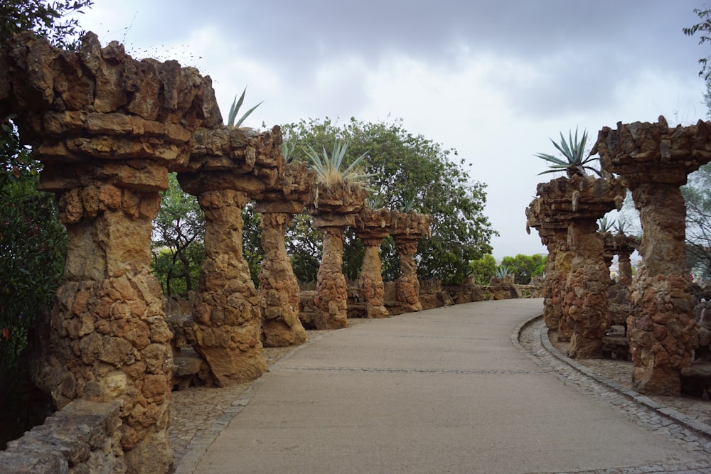 a stone walkway surrounded by trees and rocks