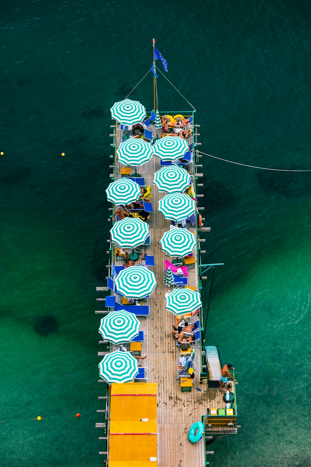 an overhead view of a pier with umbrellas