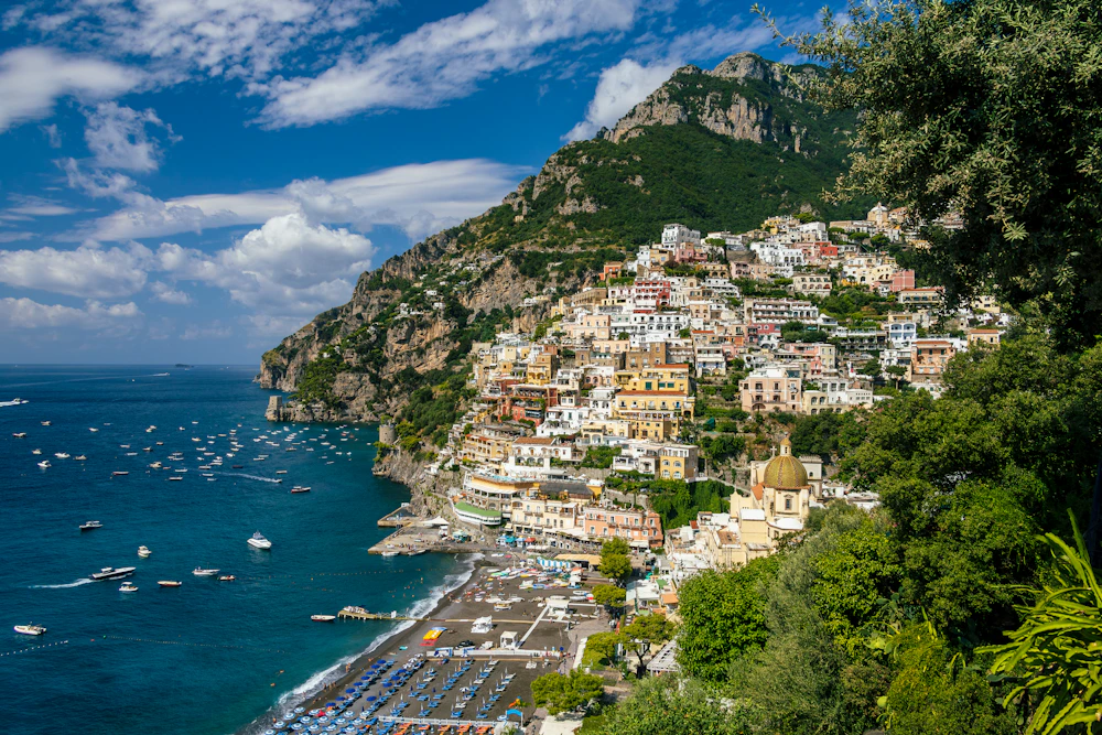 Colorful cliffside buildings and blue water in Positano, Italy