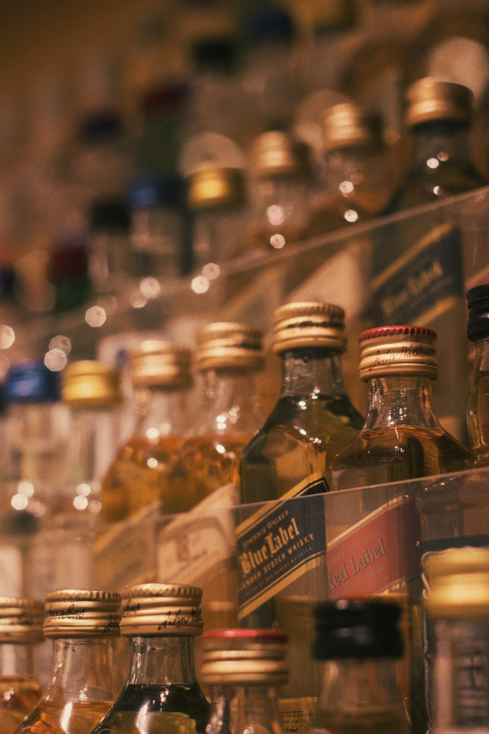 a shelf filled with lots of bottles of liquor