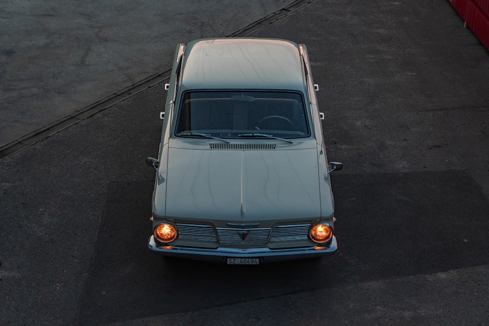 an old car is parked in a parking lot