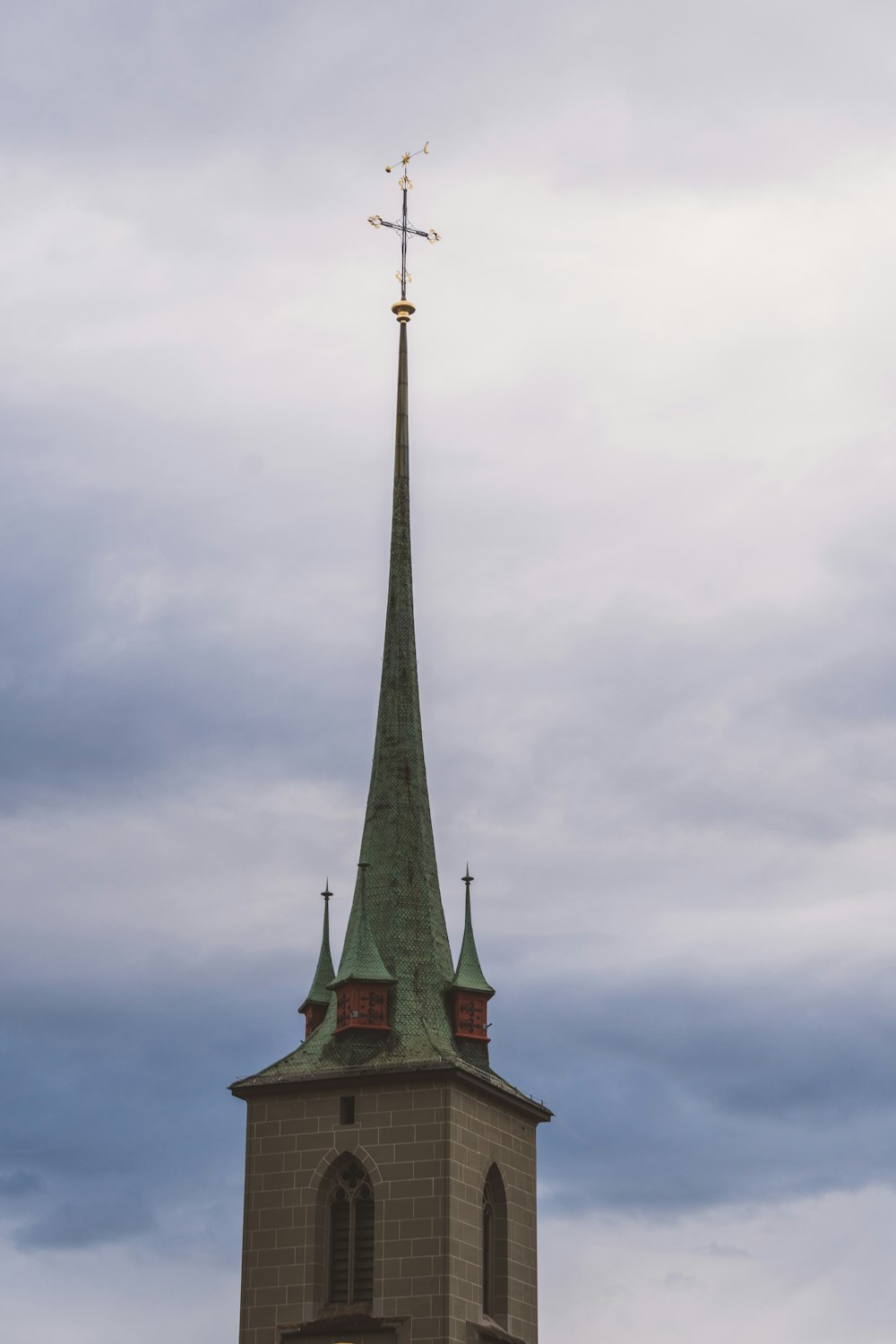 a church steeple with a weather vane on top