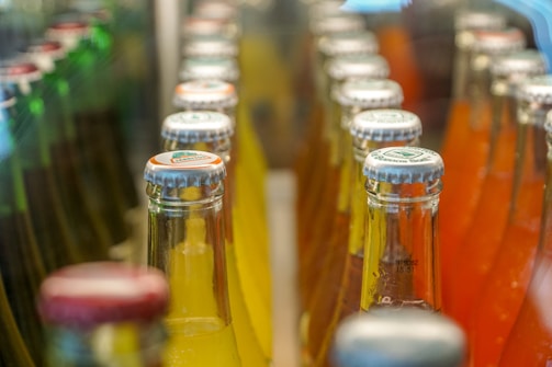 a close up of many bottles of soda