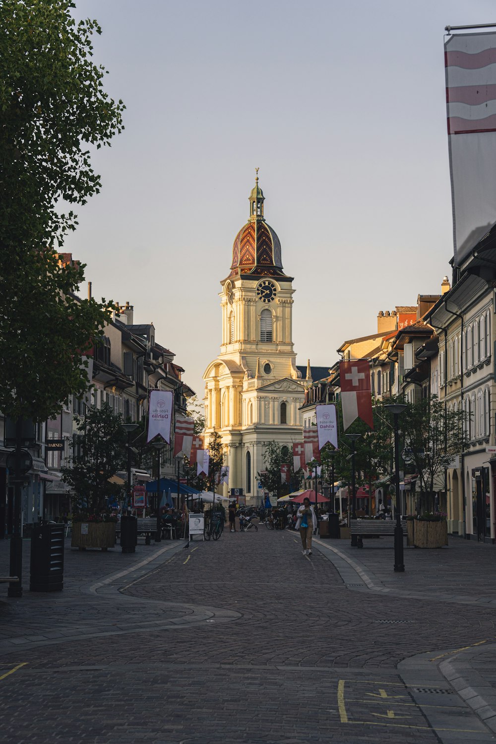 a city street with a clock tower in the background