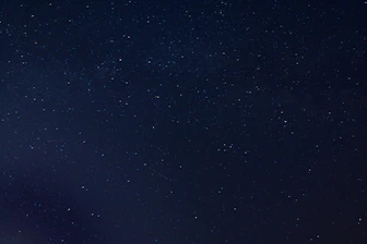 the night sky is full of stars and a few clouds