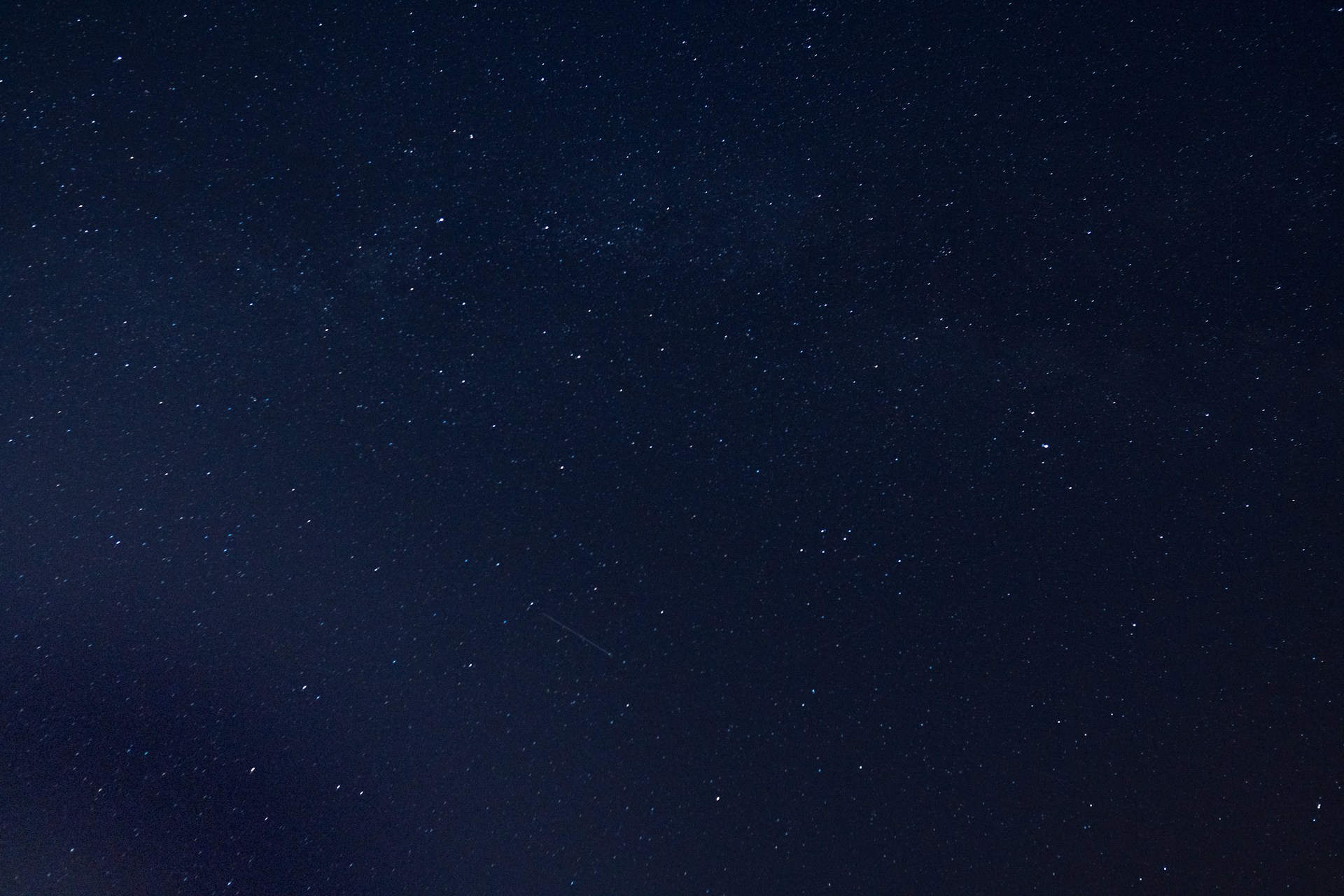 the night sky is full of stars and a few clouds