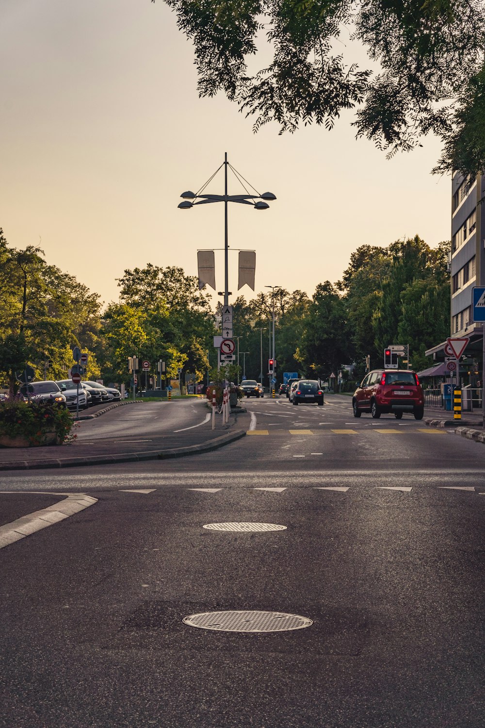 a city street with cars parked on the side of the road