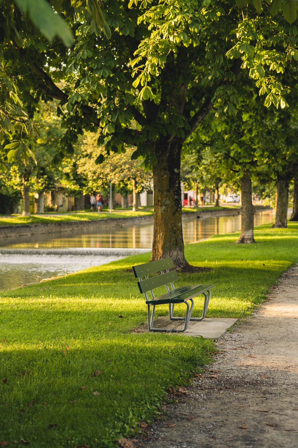 a park bench sitting next to a river