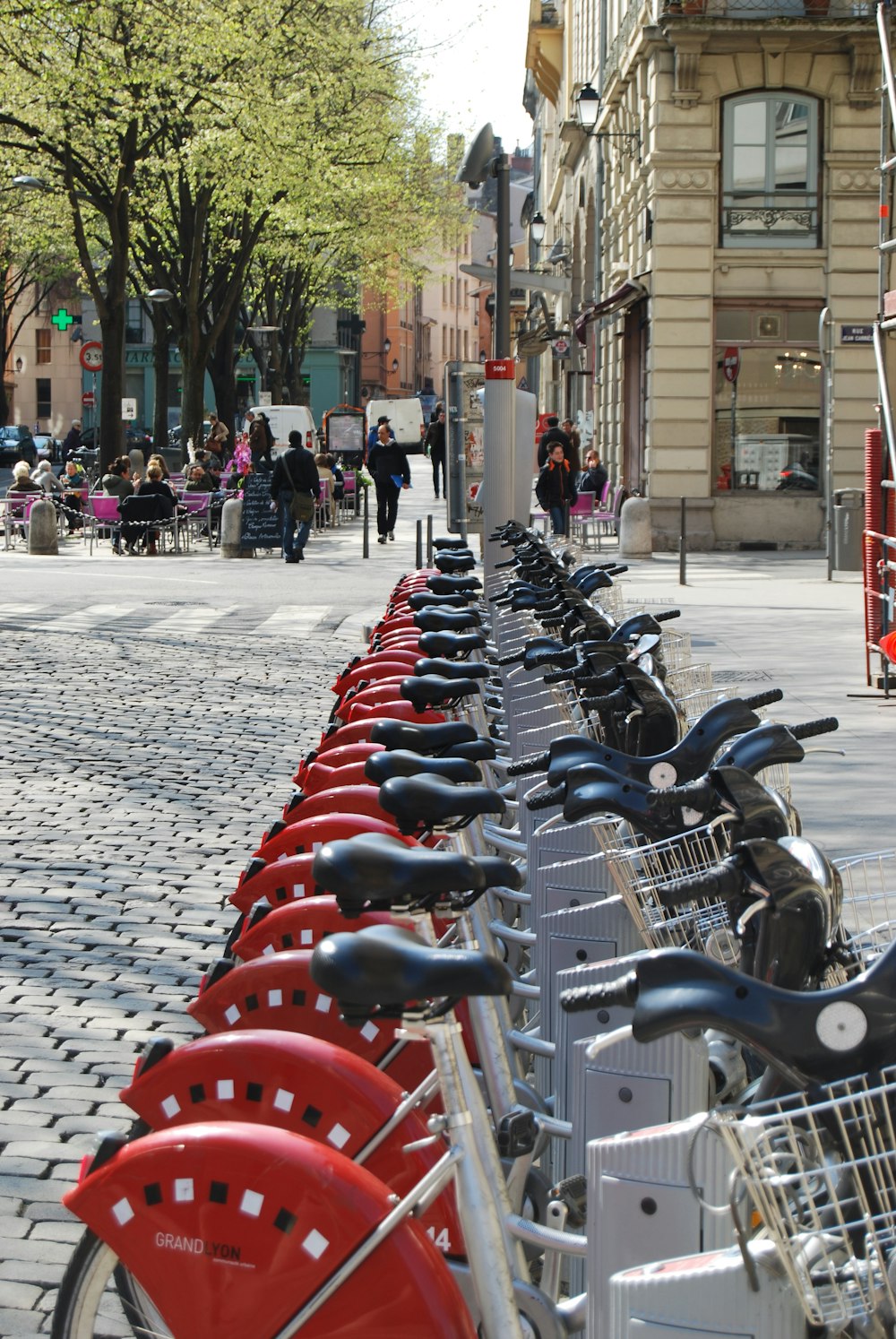 a row of bikes parked next to each other on a sidewalk