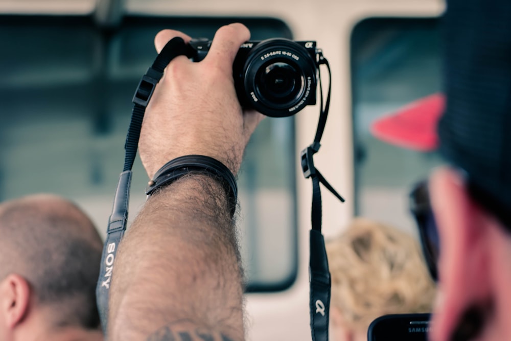 a man holding a camera up to take a picture