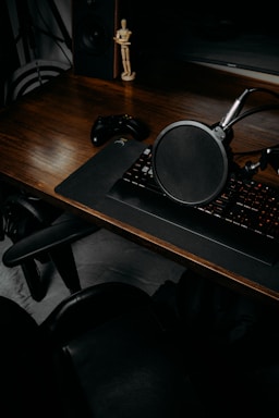 A cozy workspace with game consoles, controllers, and musical instruments neatly arranged, inviting contact.