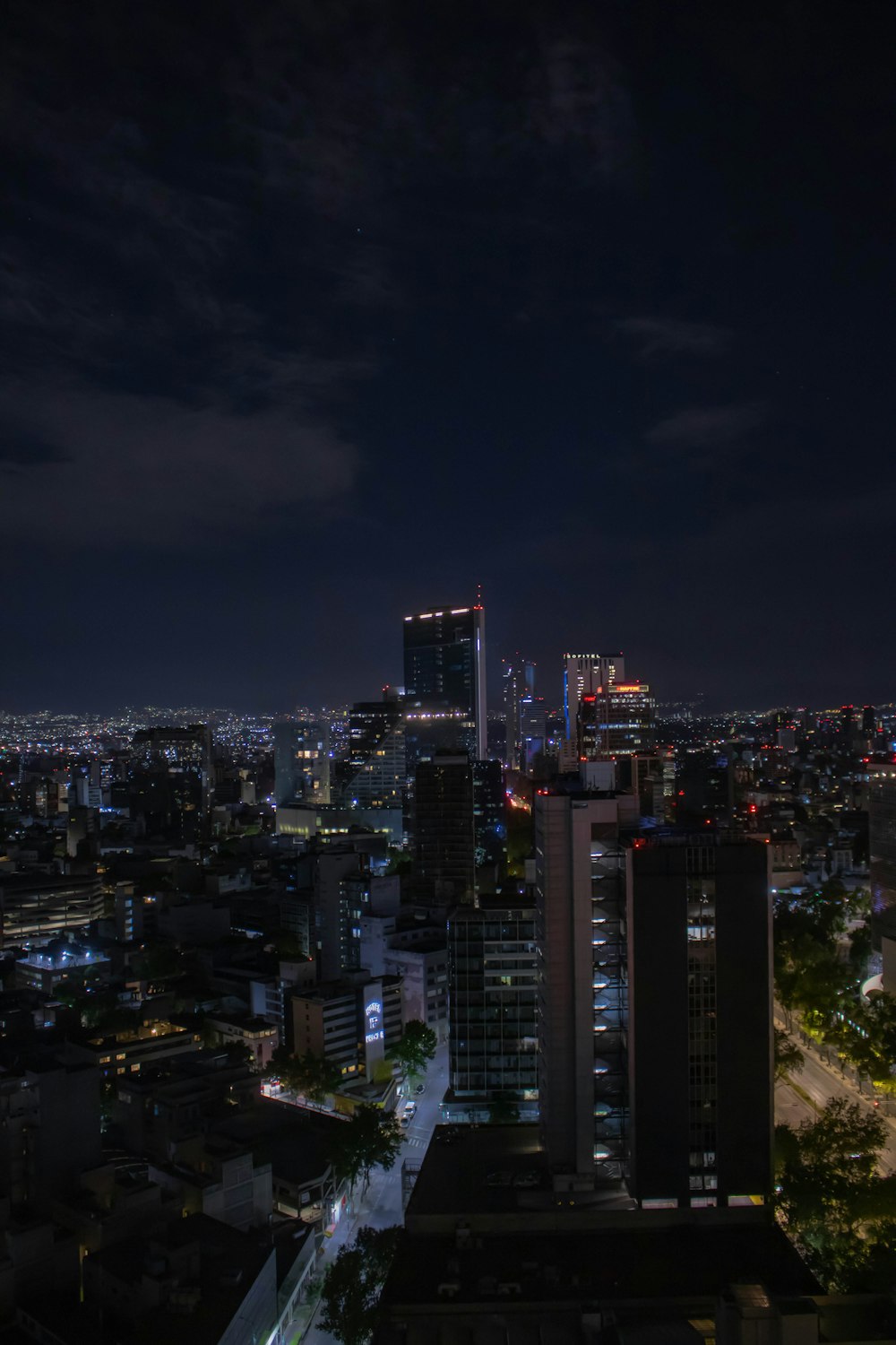 a night view of a city with tall buildings