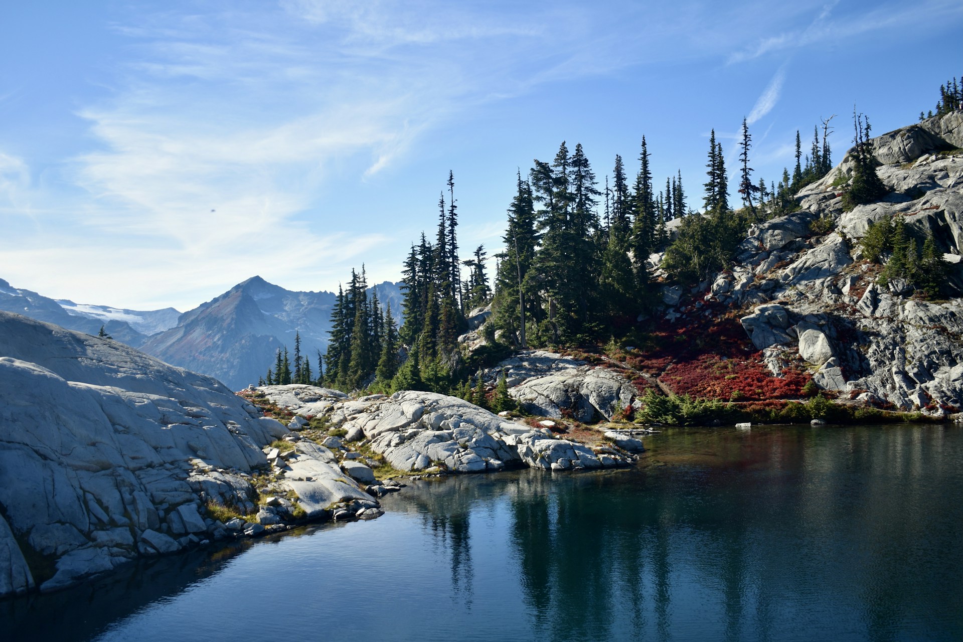 a body of water surrounded by mountains and trees