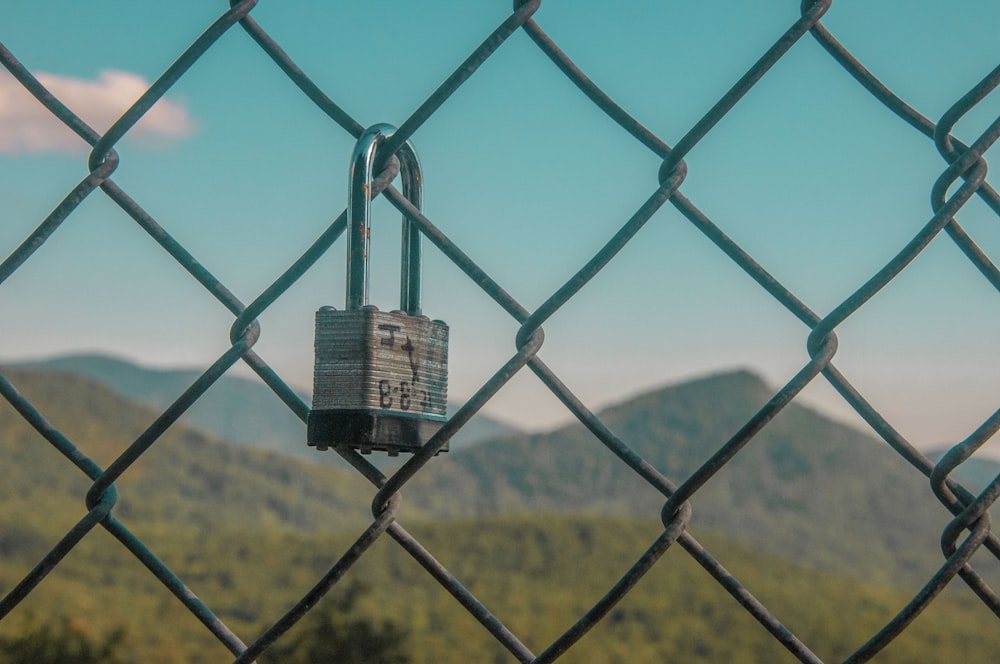 a padlock attached to a chain link fence