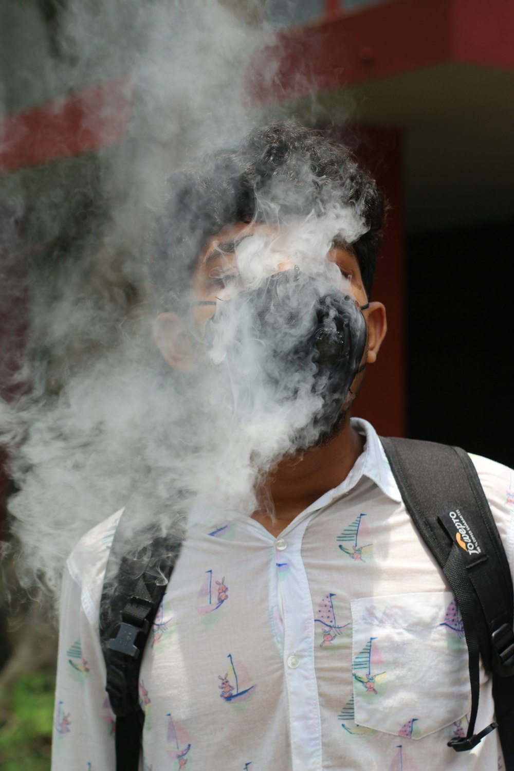 a man with smoke coming out of his mouth