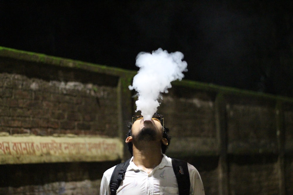 a man with a backpack is smoking a cigarette