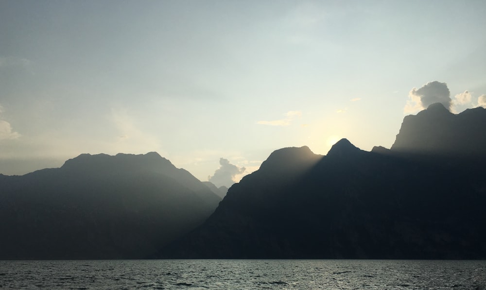 a large body of water with mountains in the background