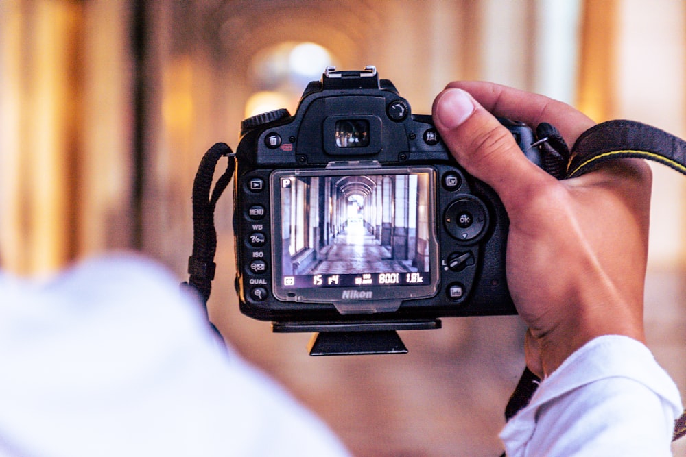 a person holding a camera up to take a picture