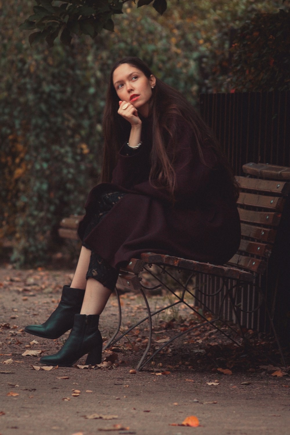 a woman sitting on a bench in a park