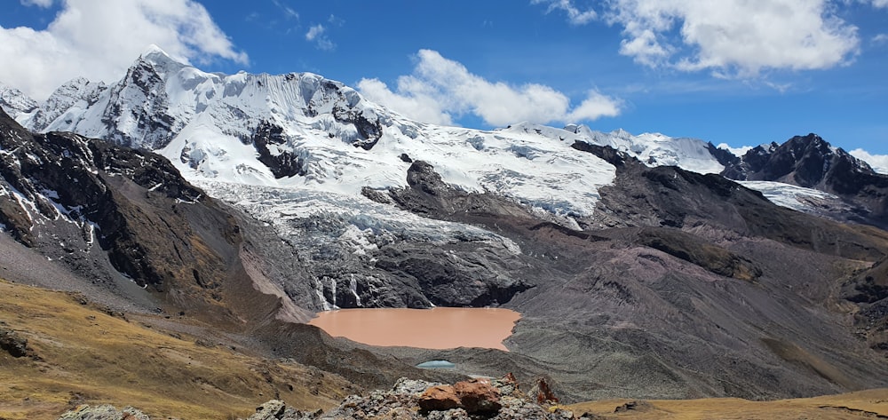 a view of a mountain range with a lake in the foreground