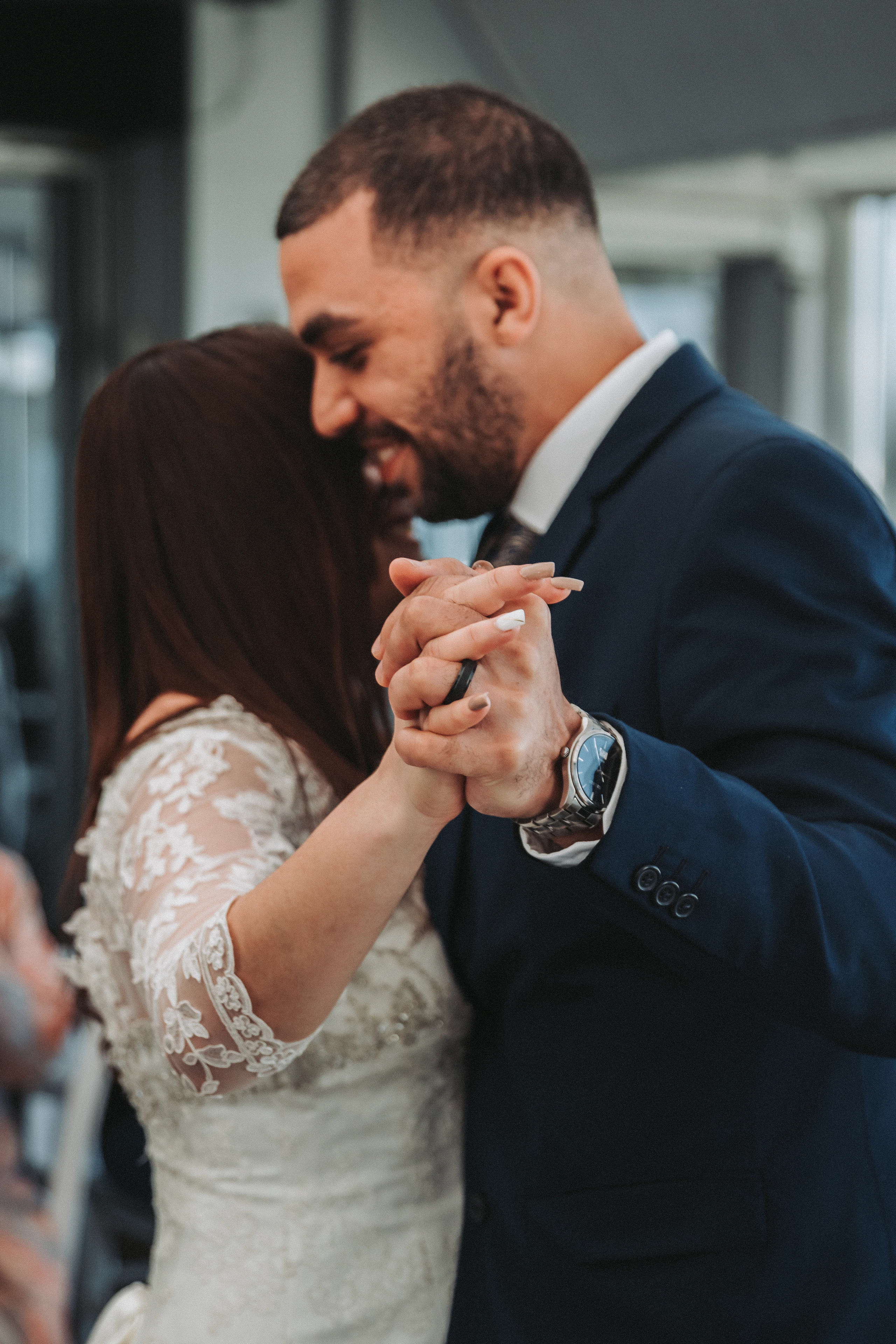 A couple holding hands on the dance floor