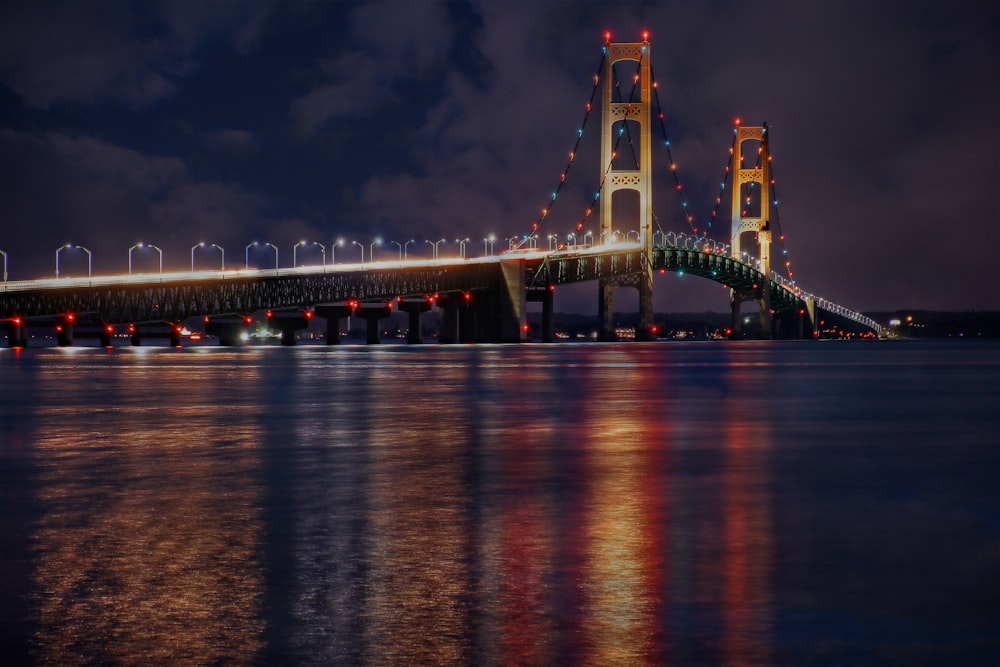 a large bridge over a body of water at night