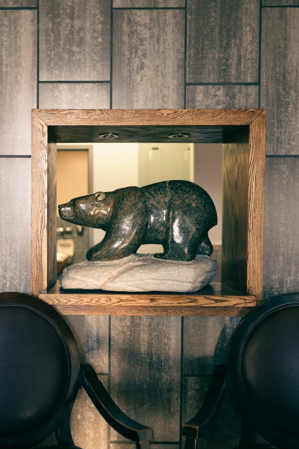 a statue of a bear in a wooden frame