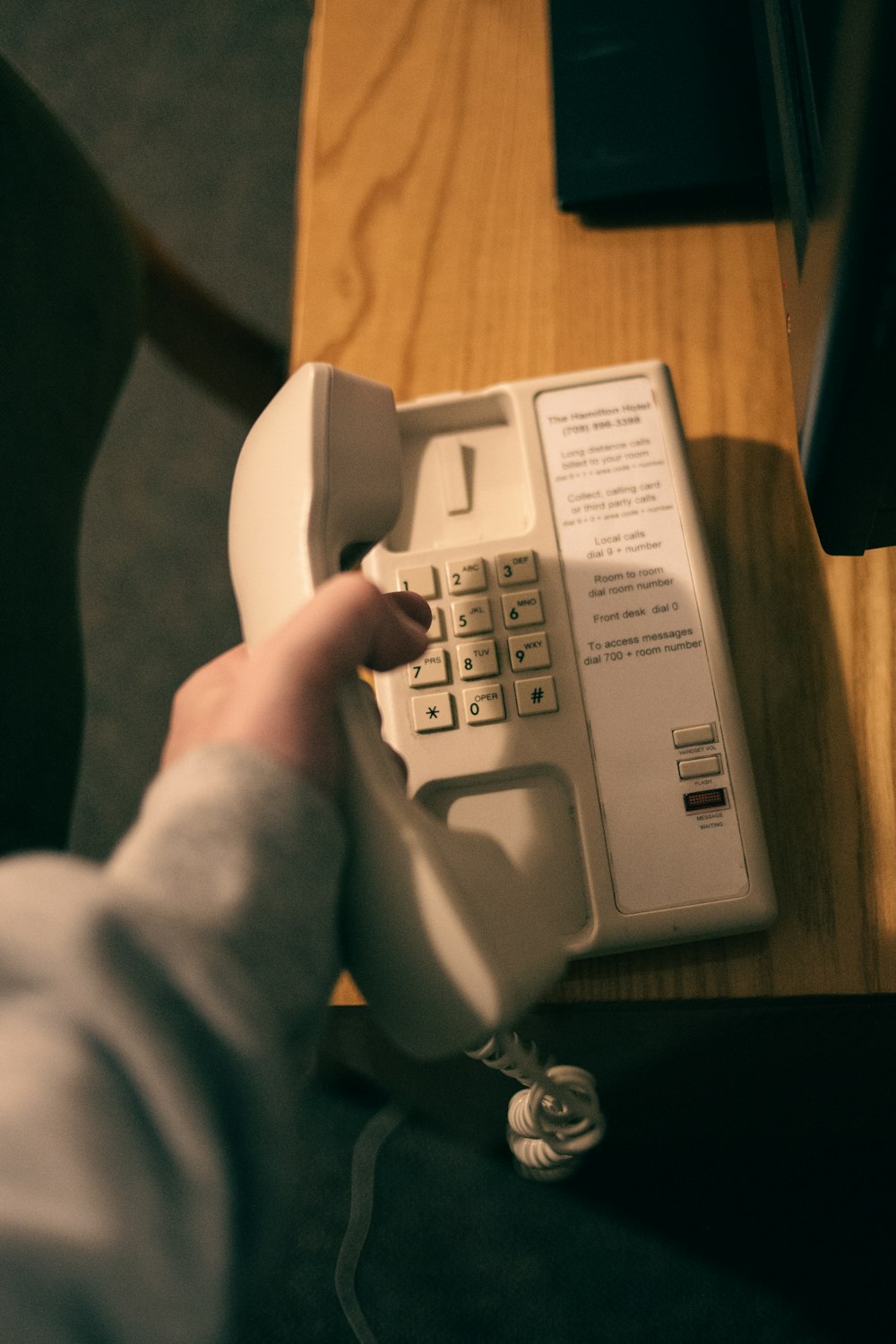 a person pressing a button on a telephone