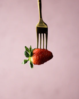 a fork that has a strawberry on it