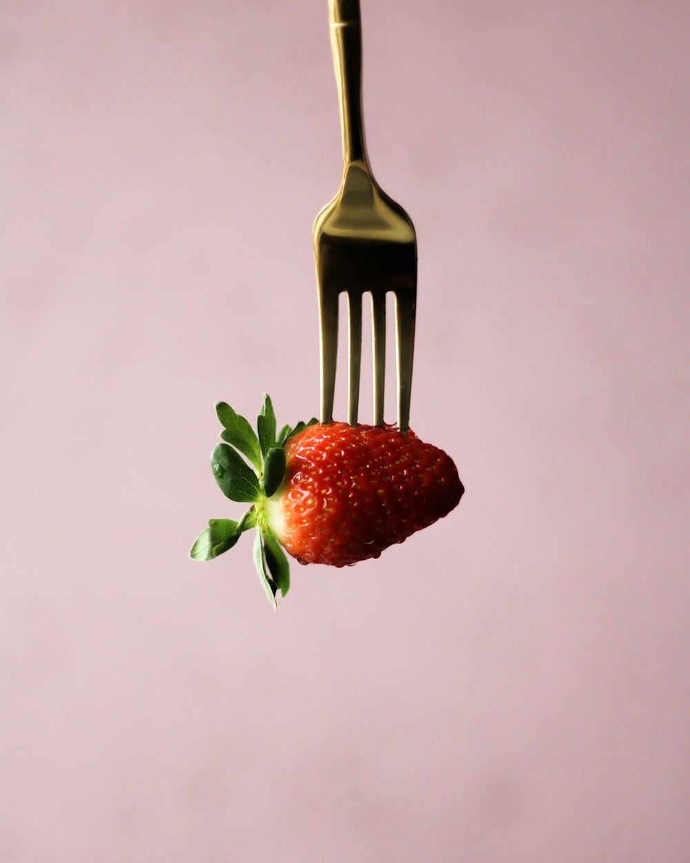 a fork that has a strawberry on it