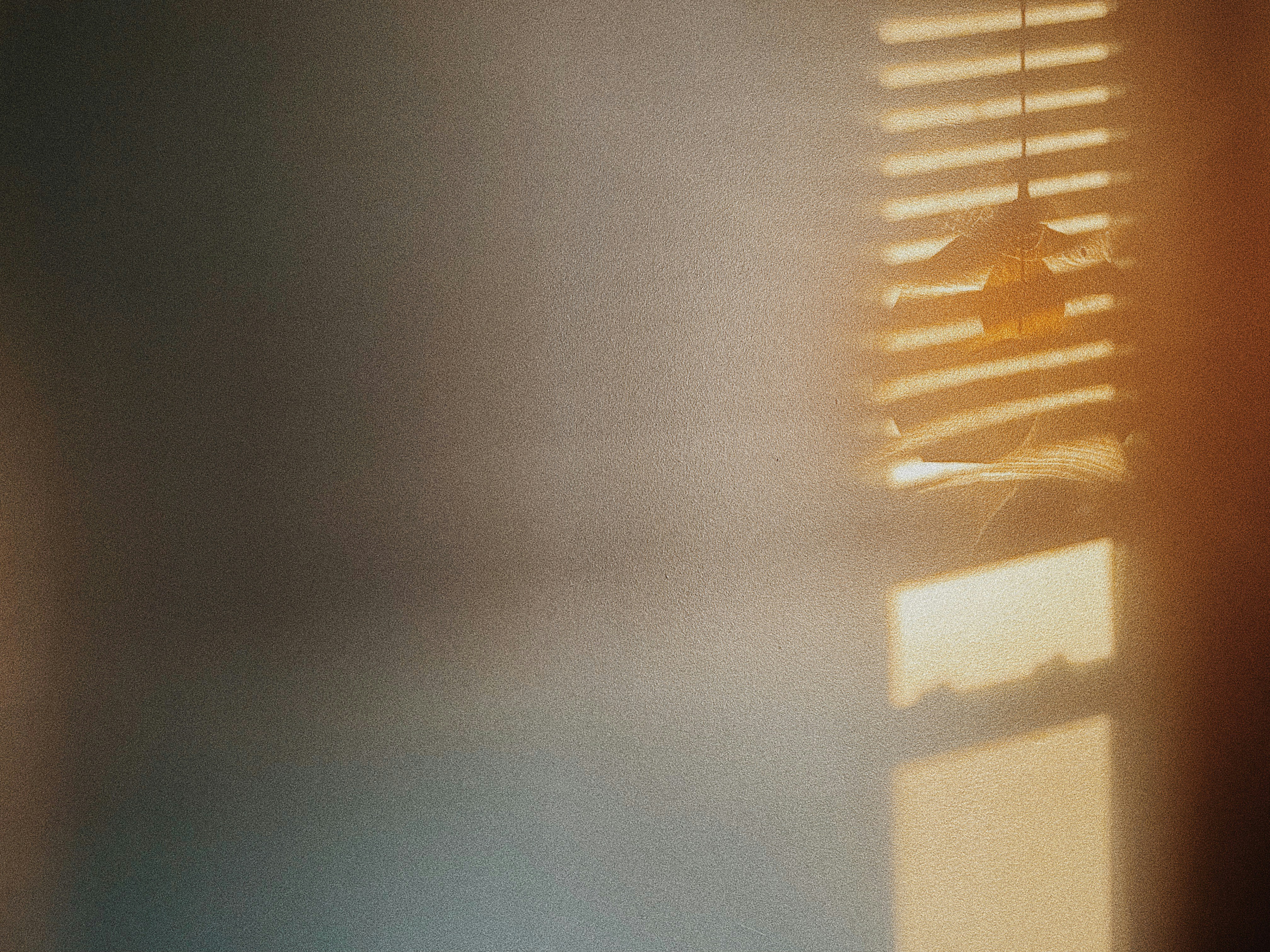 a room with a window covered in blinds